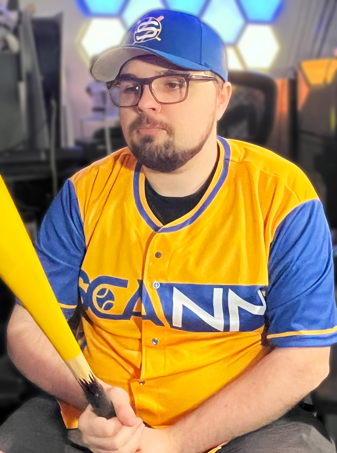Scann wearing a Royal Blue fitted FlexFit hat holding a pencil bat