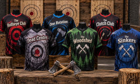 Six axe throwing jerseys on mannequins in front of wooden target boards