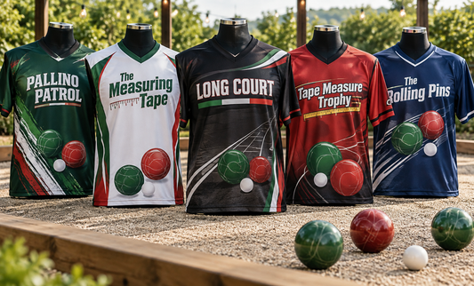 Six custom bocce jerseys on mannequins beside a court with bocce balls