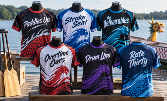 Six dragon boat jerseys on mannequins displayed by the water