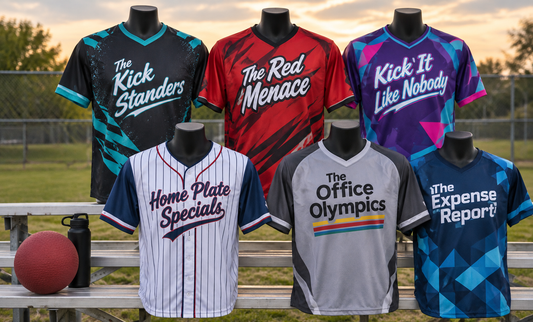 Six custom kickball jerseys on mannequins on bleachers beside a red rubber ball